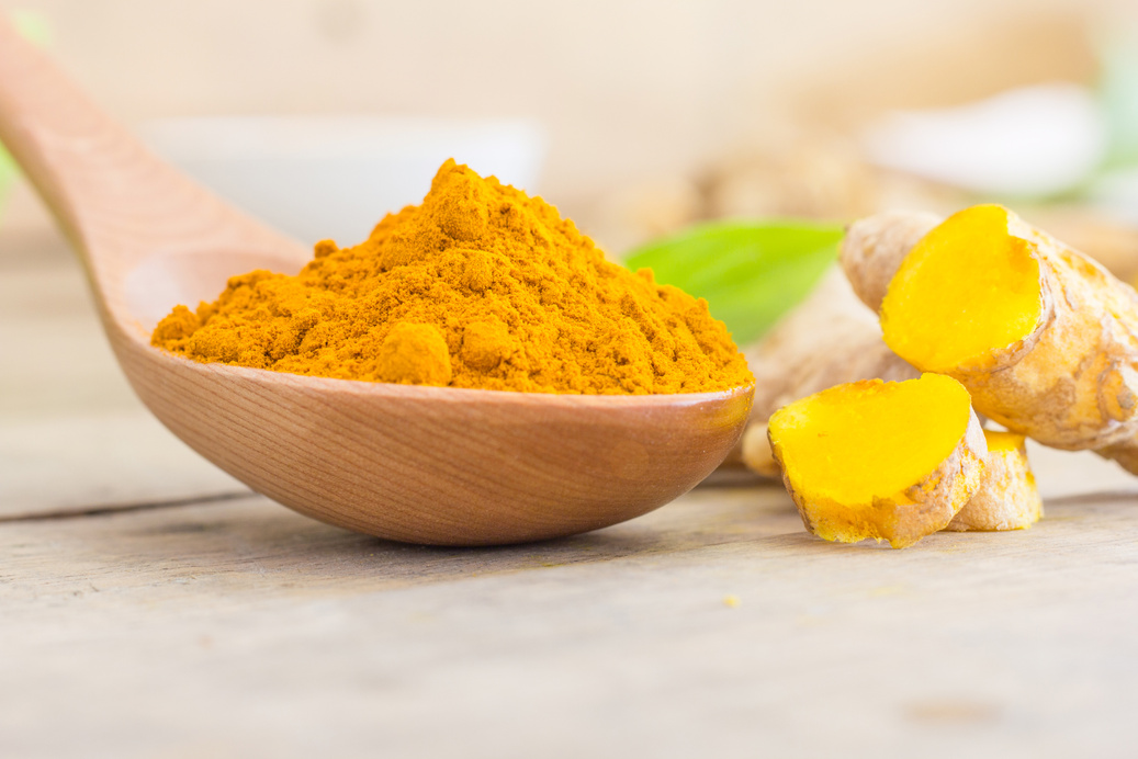Turmeric Powder in a Wooden Spoon